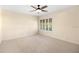 This is a bright bedroom with a ceiling fan and a window with shutters at 919 80Th Nw St, Bradenton, FL 34209
