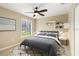 This bedroom features a ceiling fan, white shelves, and a window with a view at 919 80Th Nw St, Bradenton, FL 34209