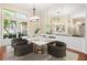 Elegant dining room with modern chandelier, marble table and window views, perfect for gatherings at 919 80Th Nw St, Bradenton, FL 34209