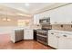Modern kitchen boasts stainless appliances, white cabinets, and tile backsplash at 919 80Th Nw St, Bradenton, FL 34209