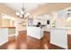 Open kitchen boasts white cabinets, mosaic backsplash, and hardwood floors at 919 80Th Nw St, Bradenton, FL 34209