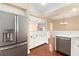 Stylish kitchen features stainless steel appliances, white cabinets, and wood flooring at 919 80Th Nw St, Bradenton, FL 34209