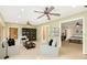 Spacious living room featuring plush white sofas, a stylish ceiling fan, and seamless access to the Primary bedroom at 919 80Th Nw St, Bradenton, FL 34209