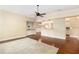 Spacious living room with hardwood floors, built-in cabinets, and modern ceiling fan at 919 80Th Nw St, Bradenton, FL 34209