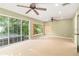 Bright living room with lots of windows, ceiling fans and carpet flooring at 919 80Th Nw St, Bradenton, FL 34209