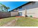This backyard features a tropical landscape and privacy fence at 1026 Longfellow Ct # 111, Sarasota, FL 34243