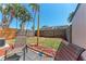 Private fenced backyard with chairs, tropical landscaping, and a patio area at 1026 Longfellow Ct # 111, Sarasota, FL 34243