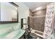 This updated bathroom features a modern vanity and glass bowl sink, plus a tiled shower at 1026 Longfellow Ct # 111, Sarasota, FL 34243