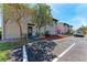 Inviting townhome exterior featuring a well-maintained lawn, mature trees, and convenient parking at 1026 Longfellow Ct # 111, Sarasota, FL 34243