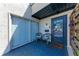 Relaxing front porch features outdoor seating, providing a comfortable space to welcome guests at 1026 Longfellow Ct # 111, Sarasota, FL 34243