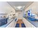 Well-lit kitchen with white cabinetry, modern appliances, and ample counter space at 1026 Longfellow Ct # 111, Sarasota, FL 34243