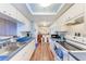 Galley kitchen with white cabinets, modern appliances, and a breakfast nook at 1026 Longfellow Ct # 111, Sarasota, FL 34243