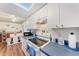 Bright kitchen featuring a stove, white cabinets, and a cozy breakfast nook at 1026 Longfellow Ct # 111, Sarasota, FL 34243