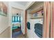 This modern laundry room is equipped with washer and dryer hookups, storage shelves and bedroom view at 1026 Longfellow Ct # 111, Sarasota, FL 34243