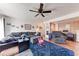 Comfortable living room featuring a large sectional, unique decor, and a ceiling fan at 1026 Longfellow Ct # 111, Sarasota, FL 34243