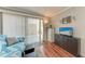 Cozy living room with sliding glass doors to the outside and wood-look laminate flooring at 1026 Longfellow Ct # 111, Sarasota, FL 34243