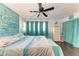 Spacious main bedroom features hardwood floors, a ceiling fan, and decorative headboard at 1026 Longfellow Ct # 111, Sarasota, FL 34243