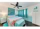 Bright main bedroom features hardwood floors, a ceiling fan, and decorative headboard at 1026 Longfellow Ct # 111, Sarasota, FL 34243