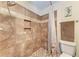 Updated walk-in shower features custom tile work, shower niche and modern shower head at 1026 Longfellow Ct # 111, Sarasota, FL 34243