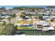Aerial showcases a home with a pool, patio, landscaping and canal, in a waterfront community at 10304 Sandpiper W Rd, Bradenton, FL 34209