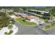 Aerial view of single-story home, showcasing lush landscaping and neighborhood canal access at 10304 Sandpiper W Rd, Bradenton, FL 34209