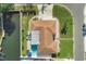 Aerial view featuring pool, patio, lush landscaping, and canal frontage on this beautiful home at 10304 Sandpiper W Rd, Bradenton, FL 34209