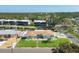 Charming light-blue single-story home with lush lawn, palm trees and nearby canal access at 10304 Sandpiper W Rd, Bradenton, FL 34209