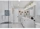 Bright bathroom with double vanity, framed mirror and walk-in glass shower at 10304 Sandpiper W Rd, Bradenton, FL 34209
