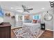 Cozy bedroom with modern ceiling fan, light walls, wood floors and bright windows at 10304 Sandpiper W Rd, Bradenton, FL 34209
