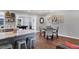 Open-concept dining area features modern lighting, seating for four, and leads to the game room at 10304 Sandpiper W Rd, Bradenton, FL 34209