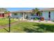 A charming home with meticulous landscaping, decorative shutters, and a freshly manicured lawn at 10304 Sandpiper W Rd, Bradenton, FL 34209