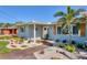 Charming single-story home with decorative shutters, stone landscaping, and a lush front yard at 10304 Sandpiper W Rd, Bradenton, FL 34209