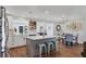 Open kitchen concept featuring a breakfast bar, white cabinets, stainless appliances, and connection to dining at 10304 Sandpiper W Rd, Bradenton, FL 34209