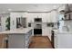 Bright kitchen with modern appliances, a large center island, white cabinetry, and an open design concept at 10304 Sandpiper W Rd, Bradenton, FL 34209