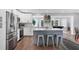 Spacious kitchen with stainless steel appliances, white cabinets, a center island, and adjacent living areas at 10304 Sandpiper W Rd, Bradenton, FL 34209