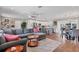 Open-concept living space featuring a comfortable sectional, wood floors, and seamless transition to the kitchen at 10304 Sandpiper W Rd, Bradenton, FL 34209