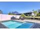 Relaxing pool with lounge chairs and a privacy fence overlooking the canal, ideal for waterfront living at 10304 Sandpiper W Rd, Bradenton, FL 34209