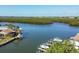 Idyllic waterfront featuring boat docks, lush trees, boats, and scenic water views at 10304 Sandpiper W Rd, Bradenton, FL 34209