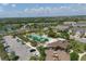 Aerial view of a resort-style pool with pool house, parking, and a view of the community at 11925 Brookside Dr, Bradenton, FL 34211