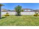 Well-maintained backyard featuring a lush green lawn and a secure white vinyl fence for privacy at 11925 Brookside Dr, Bradenton, FL 34211