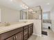 Bright bathroom with double vanity, glass shower, and luxurious soaking tub offering a spa-like retreat at 11925 Brookside Dr, Bradenton, FL 34211