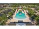 Resort-style community pool surrounded by palm trees, lounge chairs, and lush landscaping at 11925 Brookside Dr, Bradenton, FL 34211