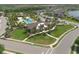 Aerial view showcasing the resort-style pool with lounge area, palm trees, and community building at 11925 Brookside Dr, Bradenton, FL 34211