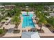 Resort style community pool with palm trees, sundeck, lounge chairs, and community building at 11925 Brookside Dr, Bradenton, FL 34211