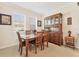 Cozy dining area with a traditional wooden table set and ample natural light from the windows at 11925 Brookside Dr, Bradenton, FL 34211