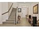 Welcoming foyer with staircase, tiled flooring, and front door, creating a warm and inviting entrance at 11925 Brookside Dr, Bradenton, FL 34211