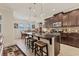 Modern kitchen with granite countertops, stainless steel appliances, and a breakfast bar island at 11925 Brookside Dr, Bradenton, FL 34211