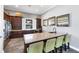 Modern kitchenette area with wood cabinetry, a granite countertop, and four chairs at 11925 Brookside Dr, Bradenton, FL 34211