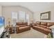 Cozy living room with vaulted ceilings, neutral walls, carpet, and leather sofas creating an inviting atmosphere at 11925 Brookside Dr, Bradenton, FL 34211