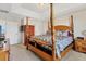 Spacious main bedroom with four-poster bed and ceiling detail, offering a relaxing retreat at 11925 Brookside Dr, Bradenton, FL 34211